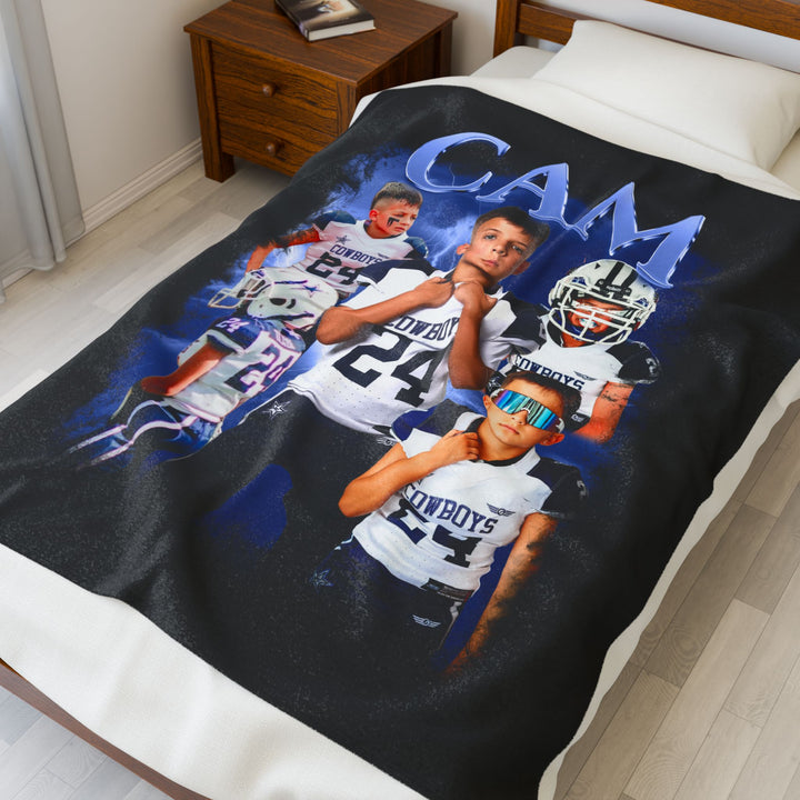 Blanket with sports-themed design featuring a young boy in a Cowboys jersey on a bed.